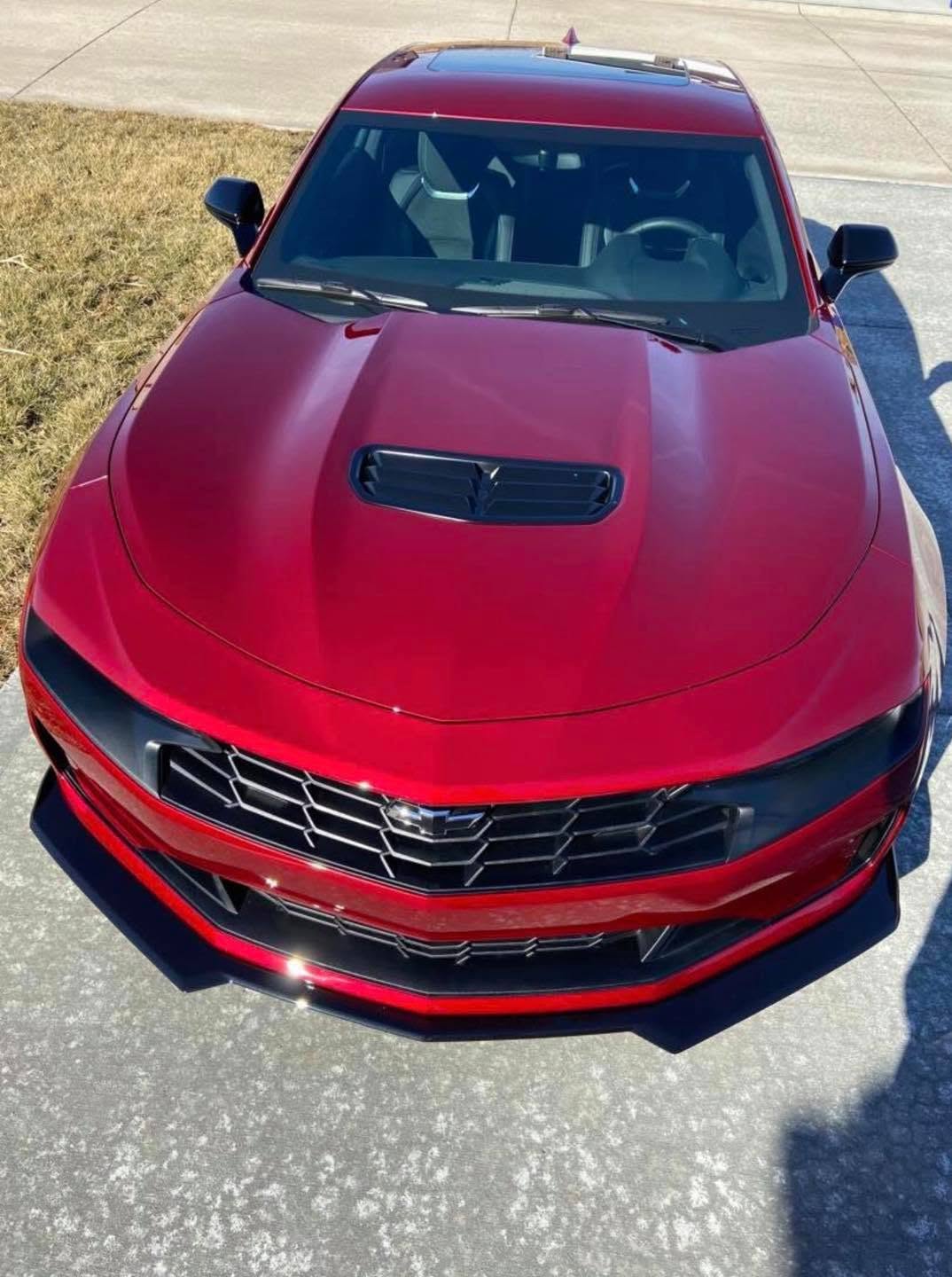 Deep red Camaro hood after a full exterior detail